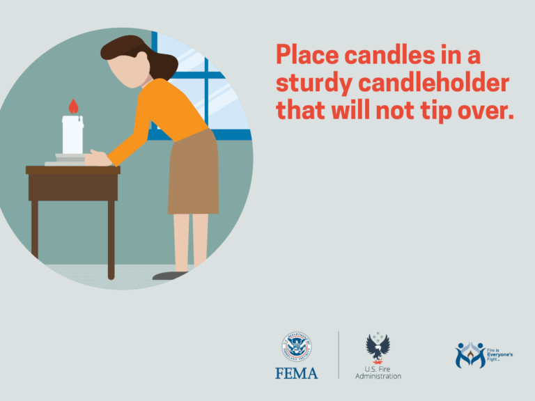Illustration of a person placing a lit candle in a sturdy candleholder on a table. Text reads: "Place candles in a sturdy candleholder that will not tip over." Logos for FEMA, U.S. Fire Administration, and Fireworks Safety are at the bottom.