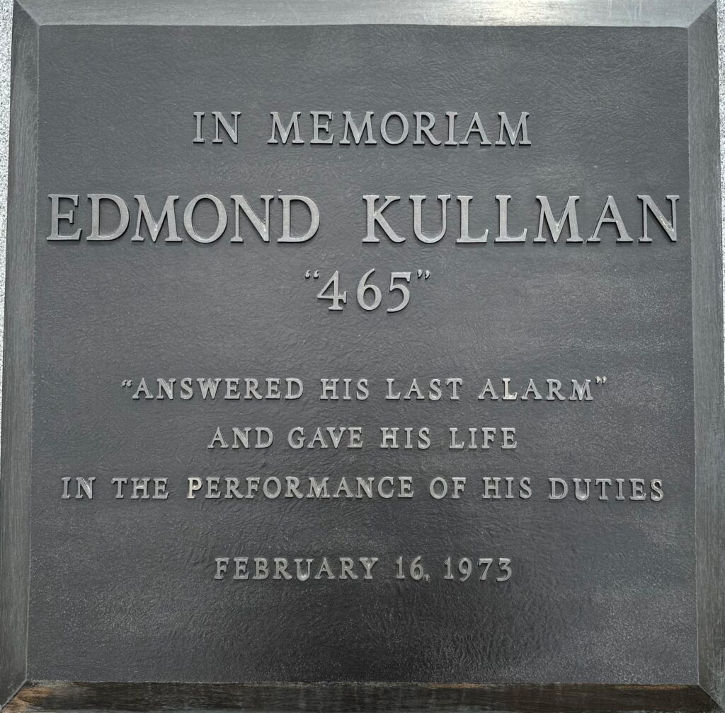 Bronze plaque reading: "In Memoriam Edmond Kullman '465' 'Answered his last alarm' and gave his life in the performance of his duties February 16, 1973.
